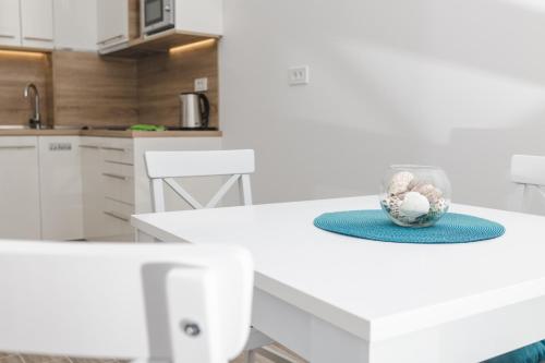 a kitchen with a white table with a bowl on it at La barca apartments in Becici