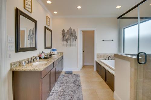 a bathroom with two sinks and a tub and a shower at Pet-Friendly Houston Home about 7 Mi to Downtown! in Houston