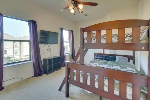 a bedroom with a bunk bed and a flat screen tv at Pet-Friendly Houston Home about 7 Mi to Downtown! in Houston