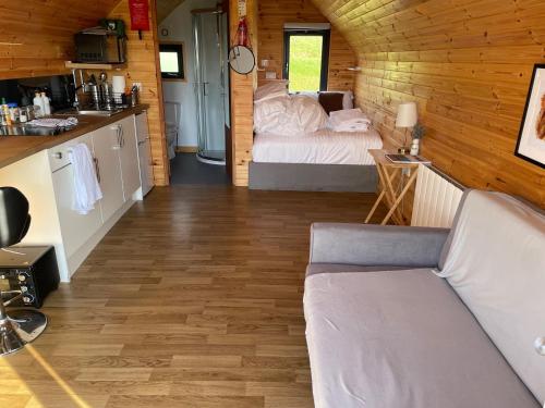 a room with a bed in a wooden cabin at Badger's Sett in Bathgate