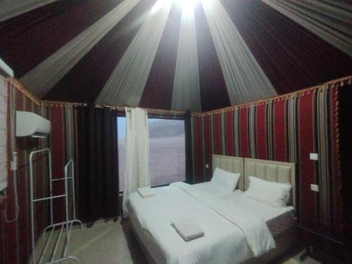 a bedroom with a large bed in a tent at Waid Rum Jordan Jordan in Wadi Rum