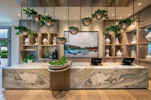 a lobby with a large counter with two laptops on it at The Westin Sacramento Riverfront Hotel & Spa in Sacramento