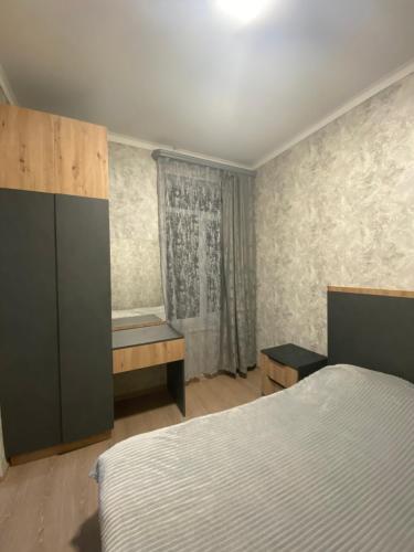 a bedroom with a bed and a desk in it at For the best in Sevan