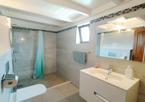 a bathroom with a sink and a toilet and a shower at Casa-la-Costa in La Costa