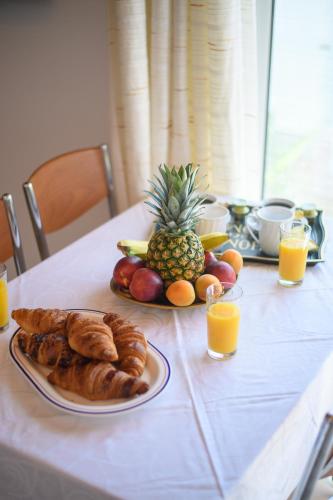a table with a plate of bread and a pineapple at Andromachi Escape! in Katávolos
