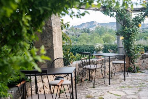 a row of tables and chairs on a patio at Hotel Hort De Fortunyo in Arnés
