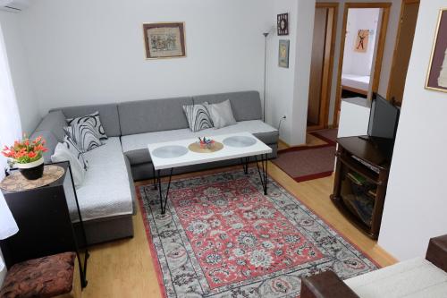 a living room with a couch and a table at Ammy apartment in Sarajevo