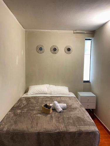 a bedroom with a bed with a stuffed animal on it at Apartamento completo Magdalena in Lima