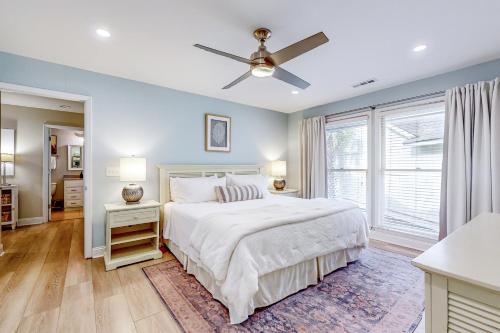 a bedroom with a bed and a ceiling fan at The Palm Frond Stay in Isle of Palms