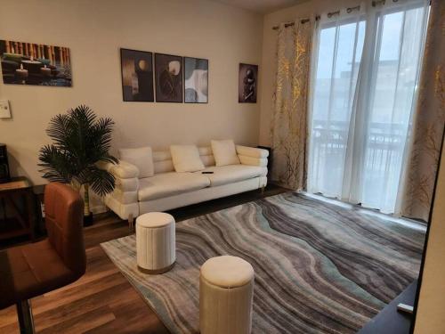 a living room with a white couch and a rug at Luxury Condo-Style Hotel In Domain Shopping Center in Austin