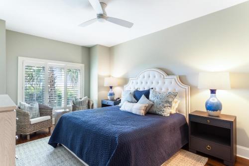 a bedroom with a bed with a blue bedspread at 3554 Seascape Oceanfront Villa in Kiawah Island
