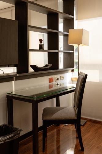 a black desk with a chair and a lamp at One Sixteen Hotel in Bogotá