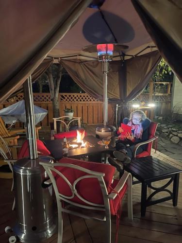 a room with a table and chairs and a person in a tent at Nightingales Inn in Ashland