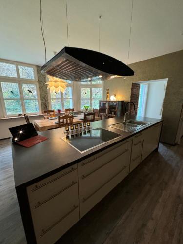 a kitchen with a sink and a counter top at Klimaanlage, 5 Sterne Bahnhoftraum, 200qm Appartement "Waldzauber", 1200qm Garten, QR Code scannen für virtuellen Rundgang, Premium Ausstattung in Braunfels