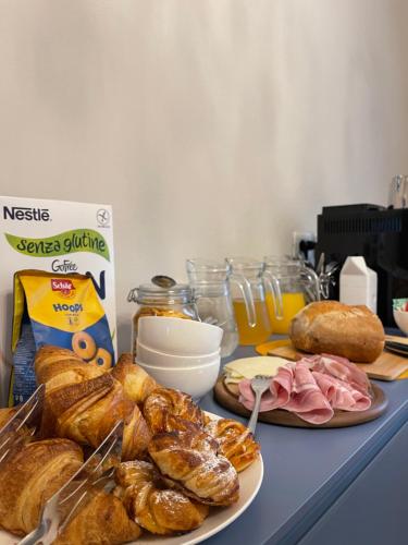 a table topped with plates of pastries and bread at CorteCairoli in Gropello Cairoli