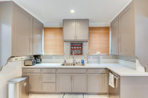 a kitchen with white cabinets and a sink at Upscale Los Angeles Retreat with Patio and BBQ Grill! in Los Angeles