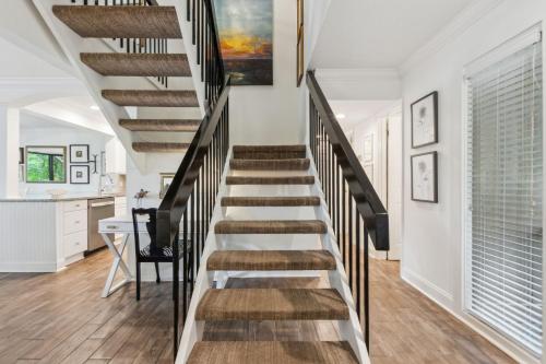 a staircase in a home with white walls and wooden floors at 2009 Beach Wood in Amelia Island