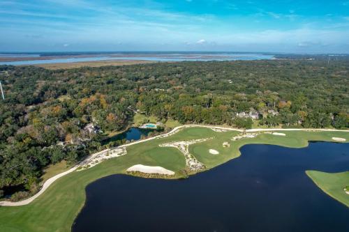 an aerial view of a golf course with a lake at 2009 Beach Wood in Amelia Island