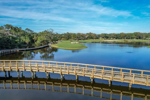 a bridge over a body of water with a golf course at 2009 Beach Wood in Amelia Island