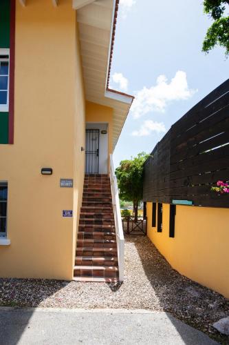 a stairway leading up to a building at Masbango Beach Resort in Jan Thiel