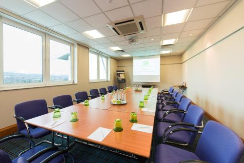 a conference room with a long table and chairs at Holiday Inn Edinburgh Zoo by IHG in Edinburgh