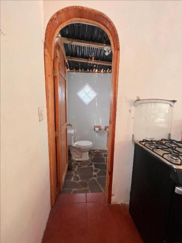 an open door to a bathroom with a toilet at Beautiful Cabin at Gaia Temple in Tzununá