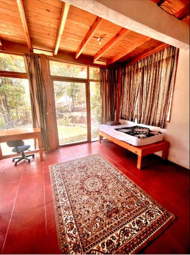 a bedroom with a bed and a rug on the floor at Beautiful Cabin at Gaia Temple in Tzununá