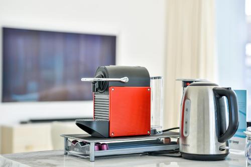 a coffee maker sitting on top of a table at Premium 2+1 BR condo in the heart of Bluewaters Island in Dubai