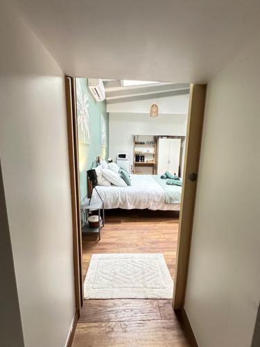 a bedroom with a bed and a mirror at Chambre indépendante au calme in Lamonzie-Montastruc