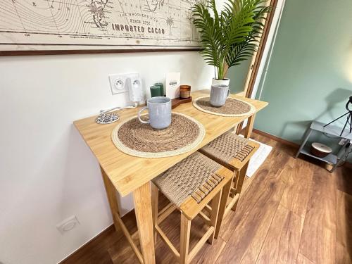a wooden table with two chairs and a plant on it at Chambre indépendante au calme in Lamonzie-Montastruc