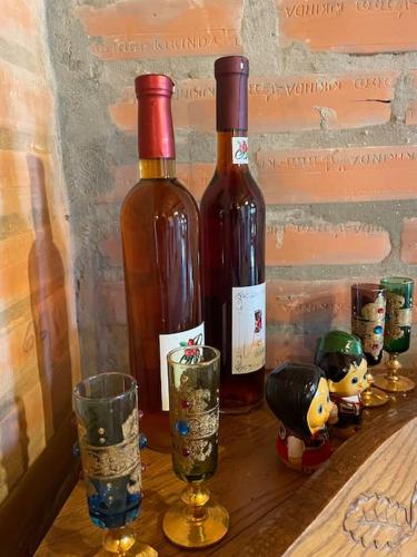 two bottles of wine and two glasses on a table at River House in Belgrade