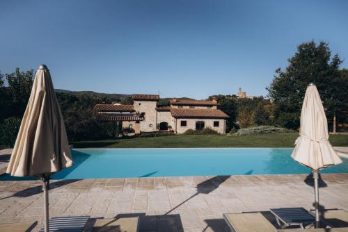 two umbrellas sitting next to a swimming pool at Agriturismo La Dolce Vista in Poppi