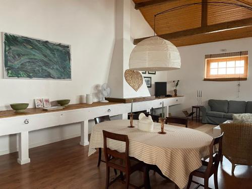 a kitchen and living room with a table and a couch at Casas Herdade do Convento da Serra in Almeirim