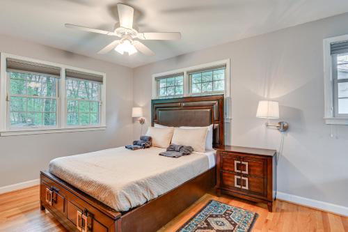 a bedroom with a bed and a ceiling fan at Eclectic Home with Private Hot Tub 14 Mi to DC! in Beltsville