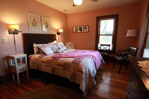 a bedroom with a bed and a window at Nightingales Inn in Ashland