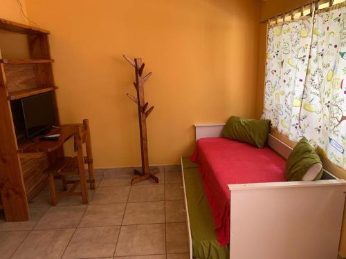 a room with a couch and a tv and a desk at Camping El Bolsón in El Bolsón