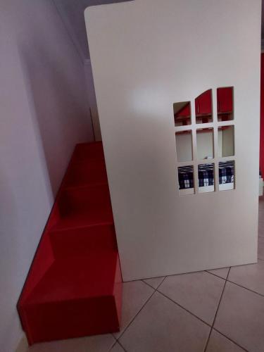 a room with red stairs and pictures on a wall at GEX Guest House in Tirana