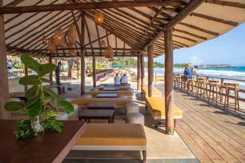 a row of tables and chairs on a beach at Sunsol Isla Caribe in Puerto Fermín