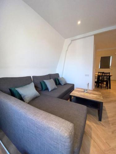 a living room with a couch and a table at Apartment City Center Terrace with Iconic View in Gouda