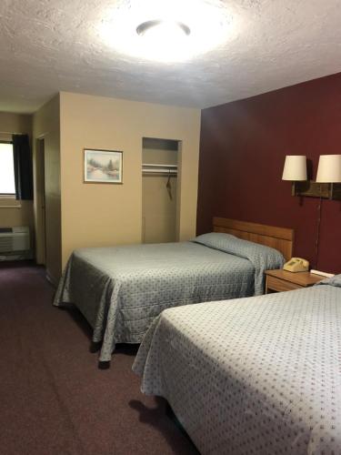 a hotel room with two beds and a lamp at Laurel Park Inn in Maggie Valley