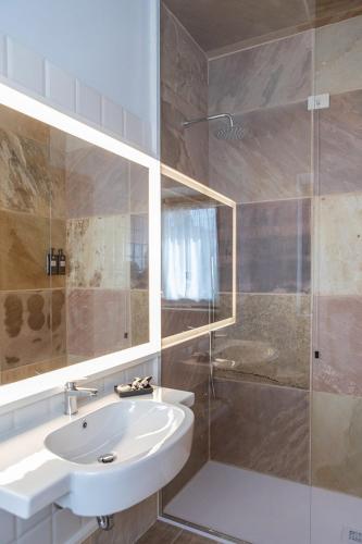 a bathroom with a sink and a shower at Villa Battibecco in Loreto