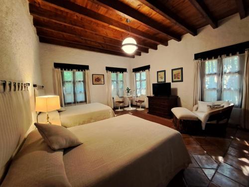 a bedroom with two beds and a living room at Areté in Tepoztlán