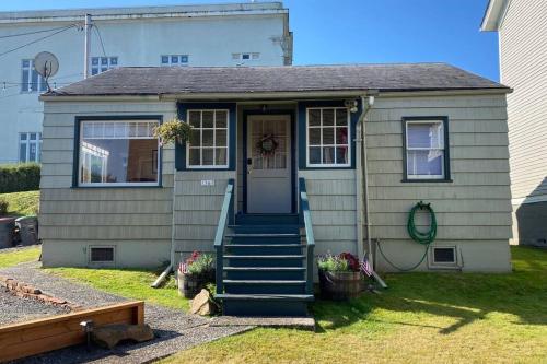 a small house with a door and a porch at Historic Downtown Cottage in Astoria, Oregon