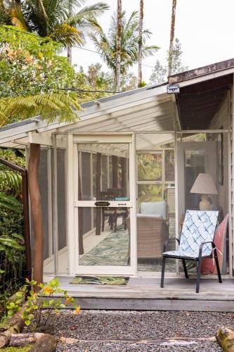 a screened in porch of a house with a chair at Lemon Tree Lanai in Keaau