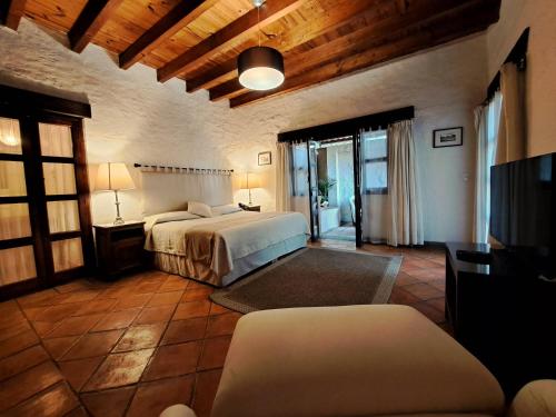 a bedroom with two beds and a tv in a room at Areté in Tepoztlán