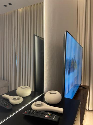 a desk with a tv and remote controls on it at شقه بغرفة نوم واحدة ودخول ذكي in Riyadh