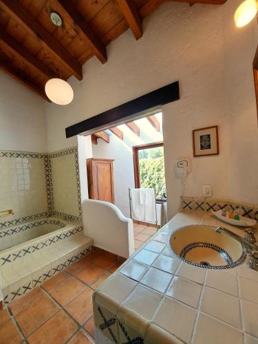 a bathroom with a sink and a large window at Areté in Tepoztlán