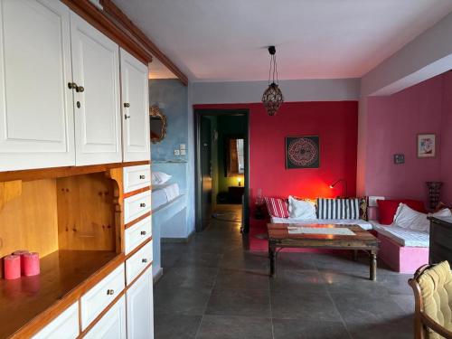 a living room with red walls and a couch at Tierra in Skiathos Town