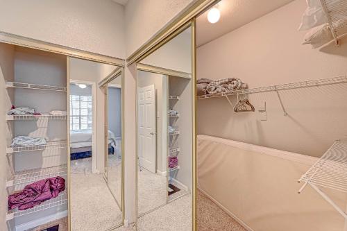 a walk in closet with a mirror and a shower at Urban Haven near NRG Stadium in Houston