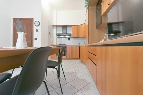 a kitchen with a table and chairs in a kitchen at QUEEN HOME Bianca in Bologna